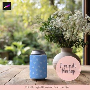 May include: A light blue can cooler with a white heart pattern. The cooler is on a wooden surface, next to a vase with white flowers. The words "Procreate Mockup" are on a pink circle.