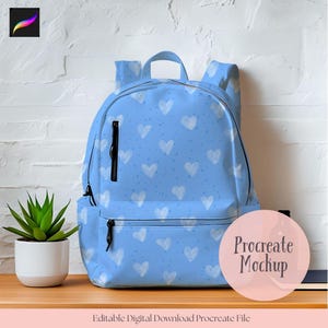 May include: A light blue backpack with a white heart pattern and black zippers. The backpack has a top handle and two front pockets. The words "Procreate Mockup" are on a pink circle. The text "Editable Digital Download Procreate File" is at the bottom.