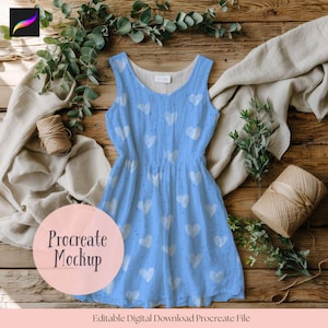 May include: A pale blue sleeveless dress adorned with a white heart design. The dress features a cinched waist and a flared skirt. The words "Procreate Mockup" are in a pink circle. The text "Editable Digital Download Procreate File" is below.