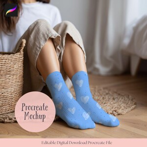 May include: A pair of light blue socks with white heart patterns. The socks are worn by a person sitting on a wooden floor. A Procreate Mockup graphic is in the foreground. The socks are a digital download file.