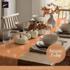 May include: A dining table set for a fall-themed meal. The table is adorned with white pumpkins, beige dinnerware, clear glasses, and a burnt orange runner with white heart patterns. A vase with autumn leaves completes the setting.