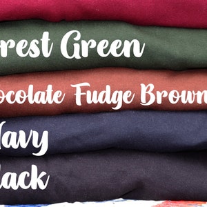 May include: A stack of five fabric swatches in different colors. The colors are, from top to bottom, burgundy, forest green, chocolate fudge brownie, navy, and black. The colors are labeled with white text.
