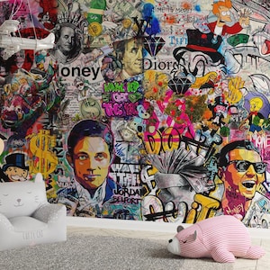 May include: A vibrant graffiti art mural featuring pop culture icons, dollar bills, and the word "money." The artwork includes portraits, cartoon characters, and abstract elements in a collage style. A white airplane sculpture hangs from the ceiling.