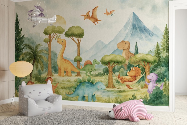 May include: A dinosaur-themed mural with watercolour illustrations of dinosaurs, trees, and mountains. A grey cat-shaped chair and a pink striped bear-shaped pillow are in the foreground. A decorative airplane hangs from the ceiling. The mural is a child's room theme.