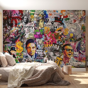May include: A vibrant, multi-colored mural featuring a collage of pop culture icons, money symbols, and graffiti art. The artwork includes portraits, cartoon characters, and the word "money". The mural is displayed on a bedroom wall, with a bed and side table in the foreground.