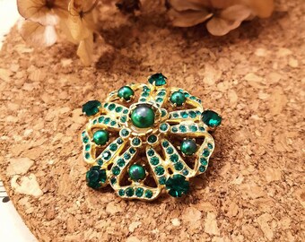 Brooch inlaid with green glass cut into a diamond shape 1950s