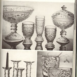 May include: A set of clear glass candle holders with a textured design. The candle holders are arranged in a row on a white surface. There is a black candle in the leftmost holder.