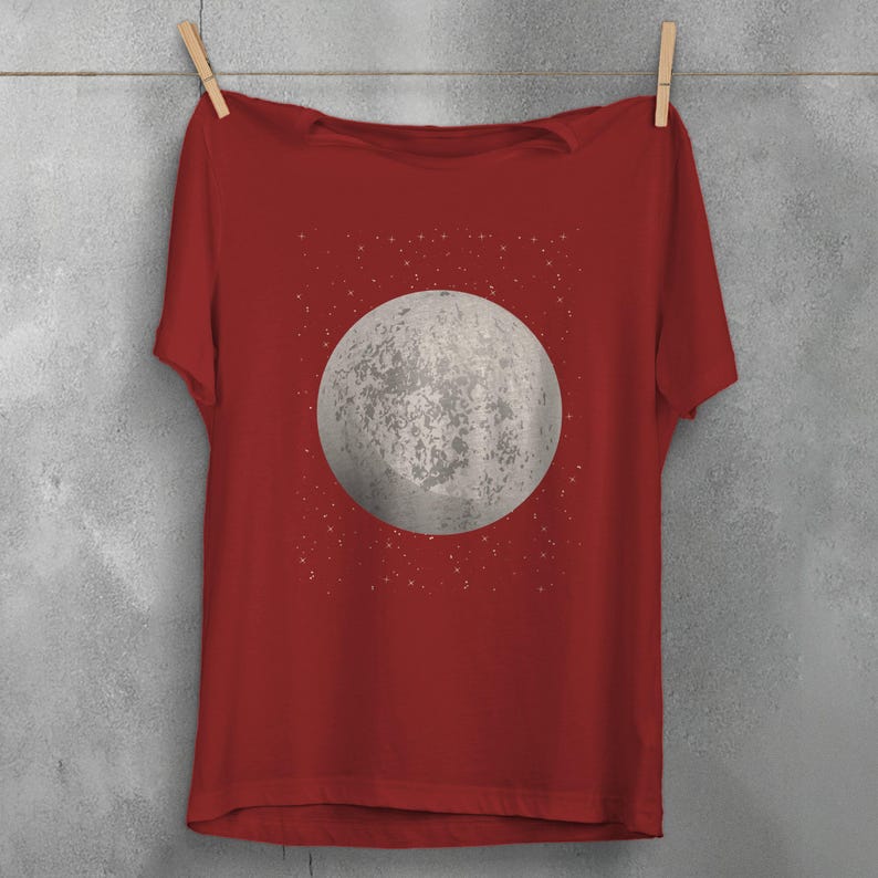 May include: A red t-shirt with a white moon and stars graphic print.