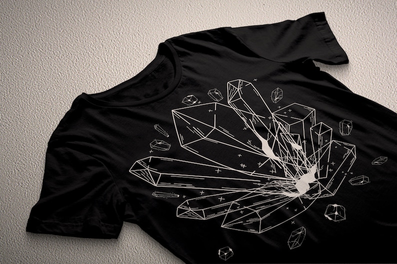 May include: Black t-shirt with a white graphic design of geometric crystals. The design features multiple crystals of different shapes and sizes.