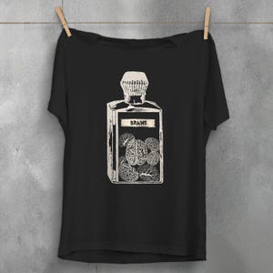 May include: Black t-shirt with a white graphic of a glass bottle labeled "BRAINS" and filled with brain shapes.
