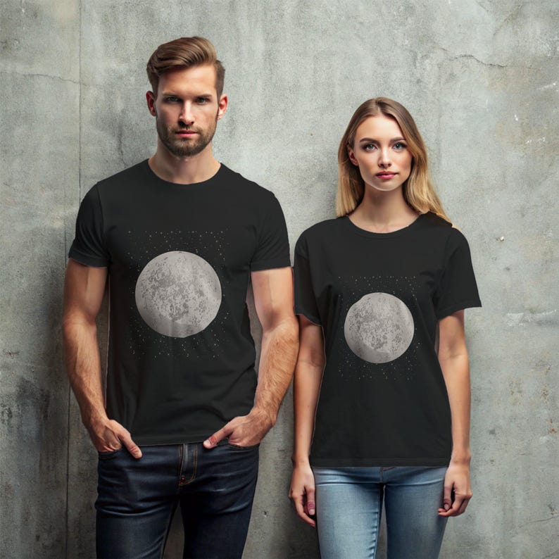 May include: Two people wearing black t-shirts with a graphic of a moon on a black background.