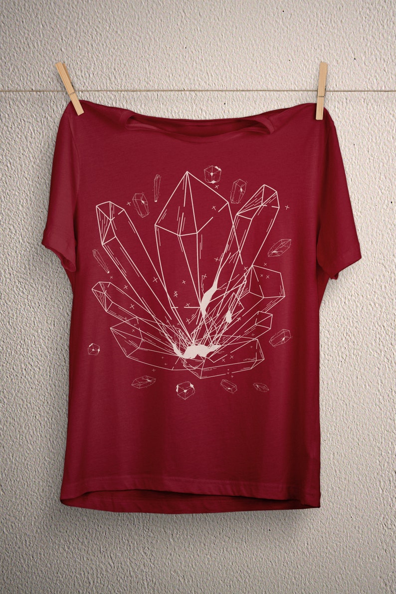 May include: A red t-shirt with a white geometric design of crystals on the front.
