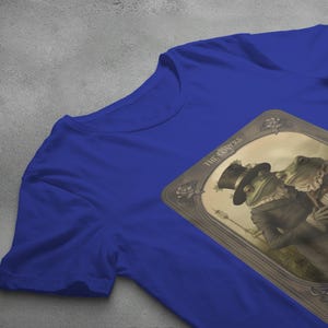 a t - shirt hanging on a clothes line with a picture of a man and