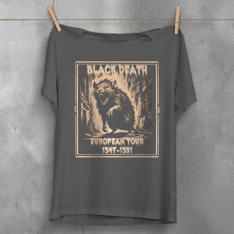 May include: A dark gray t-shirt with a graphic print of a rat in a city setting. The graphic has the text "Black Death European Tour 1347-1351".