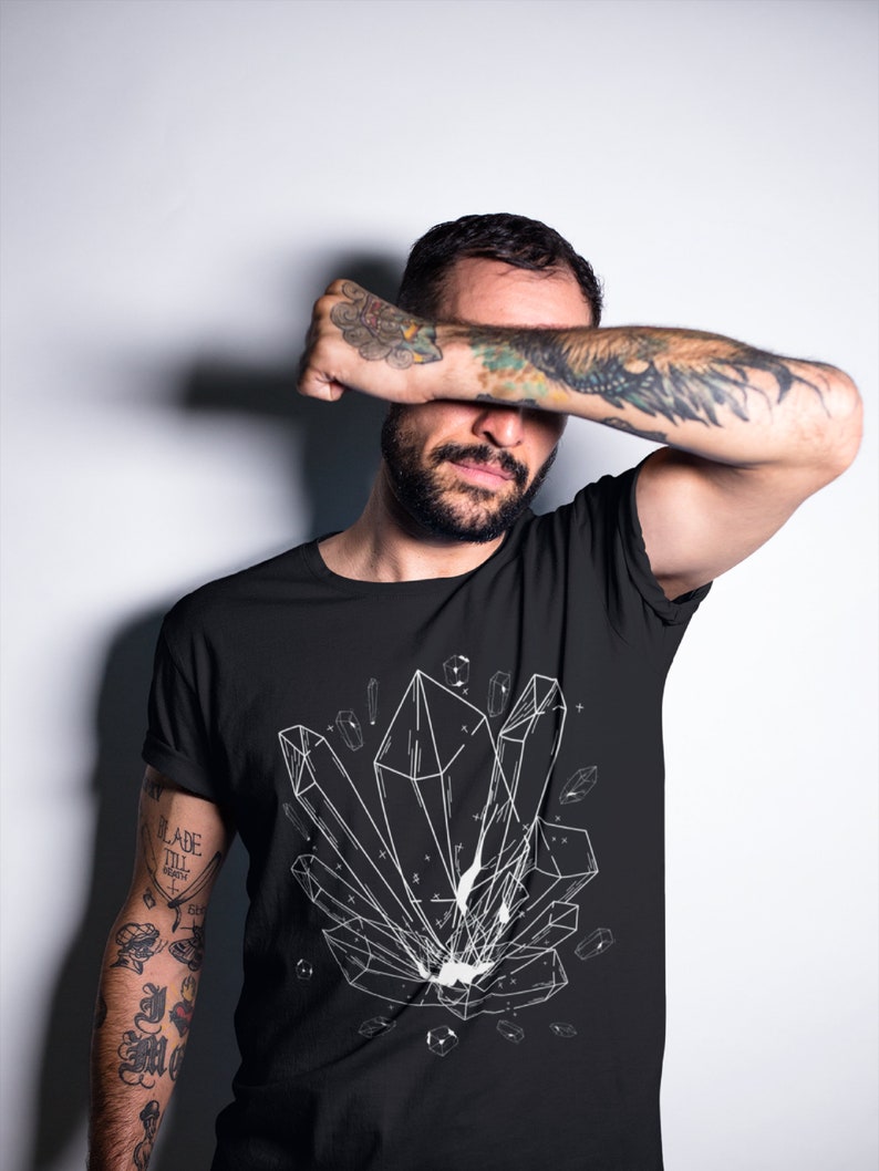 May include: A black t-shirt with a white graphic of geometric crystals. The shirt has a crew neck and short sleeves.