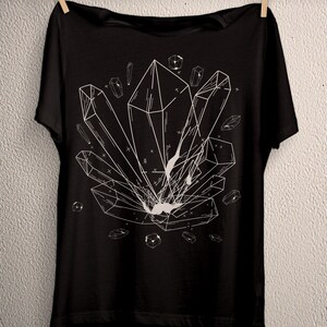 May include: Black t-shirt with a white graphic of a geometric crystal design.