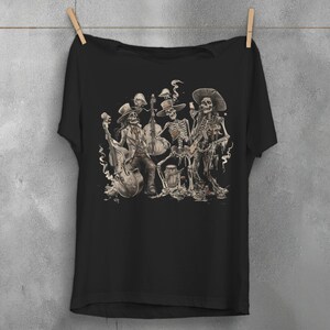 May include: Black t-shirt featuring a detailed illustration of a skeleton band playing musical instruments. The band members are dressed in hats and suits, with a double bass, cello, and guitar. The design has a vintage, slightly distressed look.