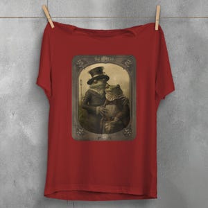 a black t - shirt with a picture of a man and a woman