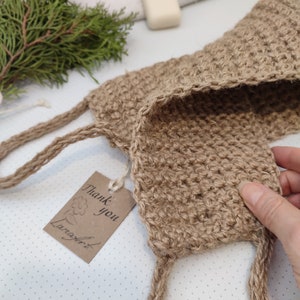 May include: A brown crocheted jute scrubby with a tag that says "Thank you LanaCraft".