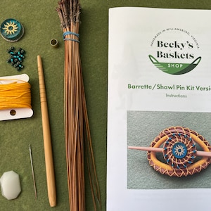 May include: A kit for making a barrette or shawl pin. The kit includes natural materials like reeds, beads, and thread. The instructions are included on a white sheet of paper with a logo for Becky's Baskets Shop. The finished product is shown in the image, a woven barrette with a blue and yellow design.