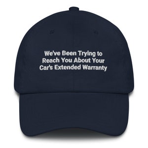 May include: A navy blue baseball cap with white embroidered text that reads "We've Been Trying to Reach You About Your Car's Extended Warranty".