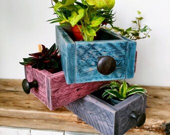 Colourful slim storage boxes, hand-crafted from pallet wood, ideal to brighten up for any room in the home.