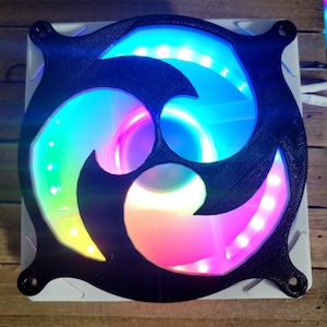 May include: A black plastic fan with a decorative design and LED lights that illuminate in a rainbow of colors.