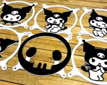 May include: Six white plastic fan grill covers with black designs. Five covers feature a black and white cartoon character with a skull on its head. One cover features a black skull design.