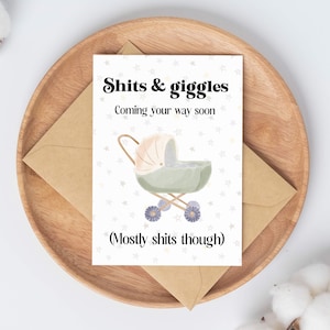 May include: A white card with a baby carriage illustration and the text "Shits & giggles Coming your way soon (Mostly shits though)"