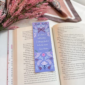 May include: A purple and pink floral bookmark with a quote from Jane Austen that reads "If a book is well written, I always find it to be too short."