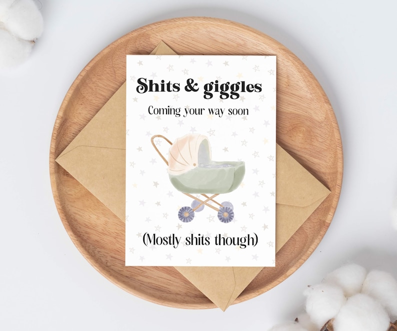 May include: A white card with a baby carriage illustration and the text "Shits & giggles Coming your way soon (Mostly shits though)"