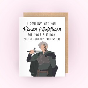 May include: A birthday card featuring a cartoon illustration of Rowan Whitethorn from the Throne of Glass series. The card has the text "I couldn't get you Rowan Whitethorn for your birthday. So I got you this card instead."
