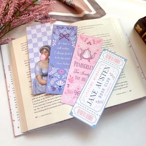 May include: Four colorful bookmarks with floral designs and quotes from Jane Austen. The bookmarks feature a checkered pattern, a woman blowing a bubble, a teapot, and a ticket with the text "Jane Austen Book Club".