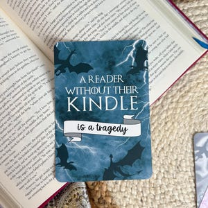 A reader without their kindle is a tragedy; dark dragon fantasy aesthetic