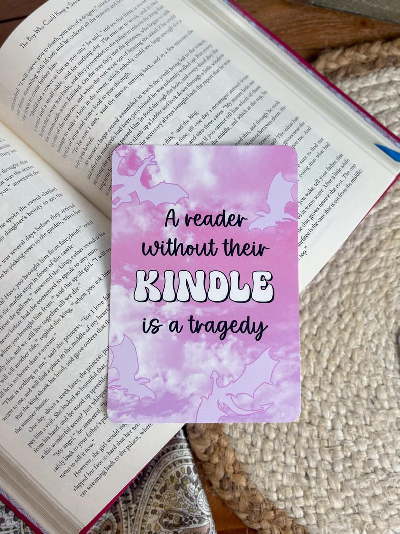 A reader without their kindle is a tragedy; pink dragon fantasy aesthetic