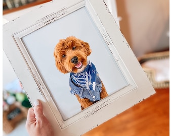May include: A framed illustration of a brown dog wearing a blue bandana. The dog is looking directly at the camera and has a happy expression. The frame is white with a distressed finish.