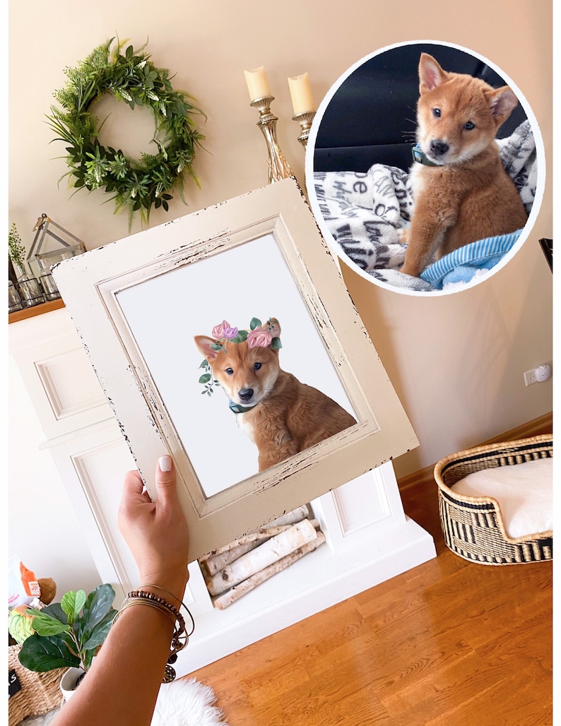 May include: A framed print of a Shiba Inu puppy wearing a flower crown. The puppy is sitting on a white background and looking at the camera. The frame is white with a distressed finish.