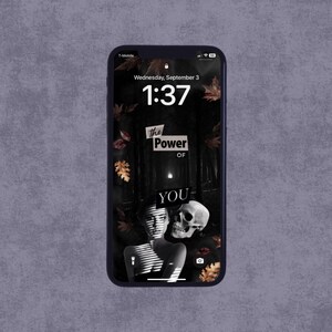 May include: A black smartphone displays a lock screen with the text "The Power of YOU." The background features a dark forest scene with a skull and a woman's face. The time is 1:37 on Wednesday, September 3.
