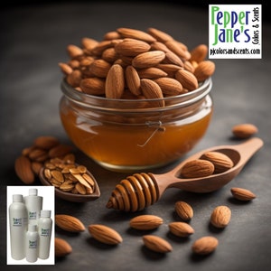 May include: A glass jar filled with almonds and honey, with a wooden honey dipper and spoon. Several almonds are scattered around the jar. The image also includes several white bottles with the text "Pepper Jane's Colors & Scents".