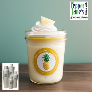 May include: A glass jar filled with a white creamy substance topped with whipped cream and a pineapple slice. The jar has a yellow and white label with a pineapple graphic and the text "Pineapple Coconut Scrub".