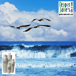 May include: A scenic image featuring three pelicans in flight over a blue ocean with crashing waves under a cloudy sky. The image includes several white bottles with the text "Pepper Jane's Colors & Scents" and the website address.
