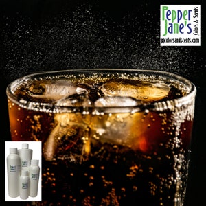 May include: A glass of cola with ice cubes, showing bubbles rising to the surface. The glass is on a black background. There are three bottles of liquid in the foreground, labeled "Pepper Jane's Colors & Scents".