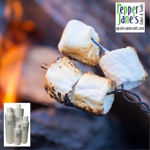 May include: Close-up of toasted marshmallows on metal skewers, with a blurred background of a campfire. The marshmallows are golden brown and white. The image includes the text "Pepper Jane's Colors & Scents" and the website address.