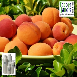 May include: A vibrant image showcases a pile of ripe apricots in a green bowl, with a few leaves in the foreground. The apricots range in color from orange to red. The image also includes several white bottles with the text "Pepper Jane's Colors & Scents".