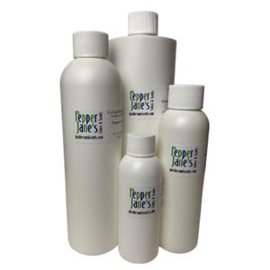 May include: A collection of white plastic bottles with white screw-on caps. Each bottle has a label with the text "Pepper Jane's" in green and the website address. The bottles vary in size, suggesting different product volumes.