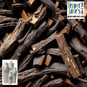 May include: A close-up image of a pile of dark brown and reddish-brown wood sticks. The sticks are arranged in a random pattern and some are stacked on top of each other. The wood sticks are dry and have a rough texture. The image also includes a small group of bottles with labels that say "Pepper Jane's" and "pjcolorsandscents.com".