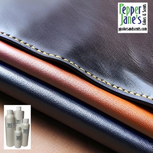 May include: Close-up of layered leather in shades of brown, orange, and navy blue. The top layer is dark brown with yellow stitching. The image includes several white bottles with the text "Pepper Jane's Colors & Scents" and the website address.
