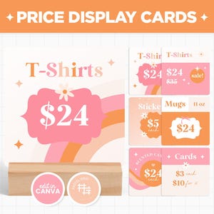May include: Price display cards with a retro design. The cards feature the text "T-Shirts" and prices, with a rainbow and flower graphic. Other cards display "Stickers", "Mugs", and "Cards". The cards are displayed on a wooden block.