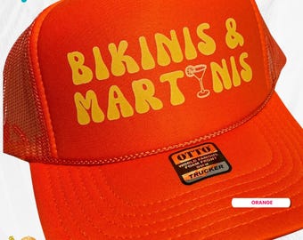 May include: Orange trucker hat with the text "BIKINIS & MARTINIS" in yellow lettering. The hat also has a small black and gold label that says "OTTO WORLD FAMOUS FOAM FRONT OSFM TRUCKER".