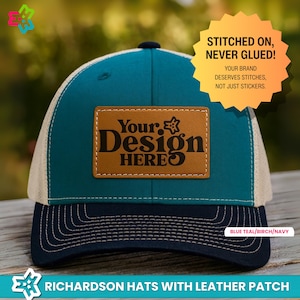 May include: A teal, birch, and navy blue Richardson hat with a leather patch. The hat features the text "Your Design HERE" on a brown leather patch. The hat's design includes the text "STITCHED ON, NEVER GLUED!" and "YOUR BRAND DESERVES STITCHES, NOT JUST STICKERS."